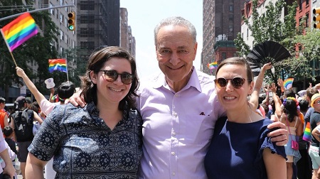 A picture of Emma with her partner and dad Chuck Schumer.